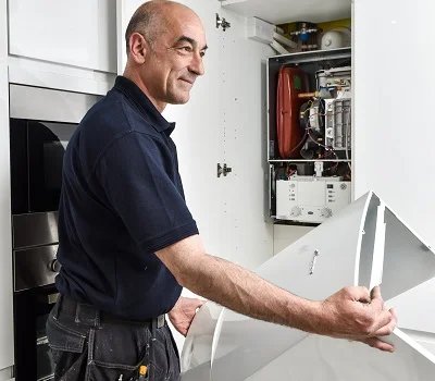 A BASI Gas Safe engineer beside a newly fitted Worcester Bosch combi boiler