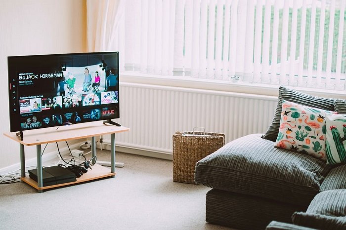 A television on in a living room using energy